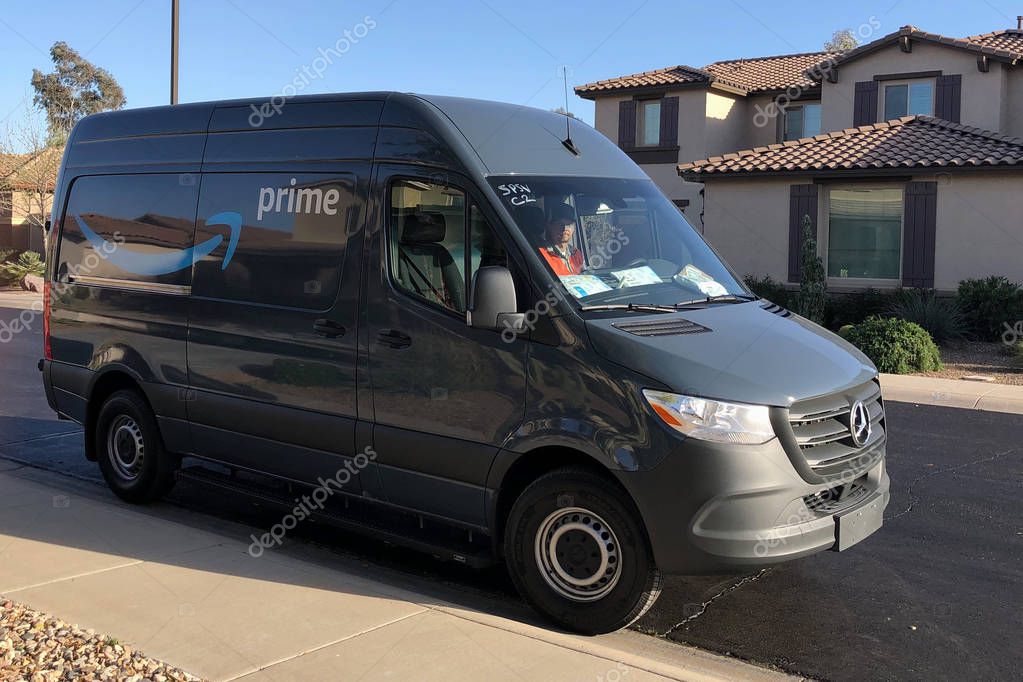 Amazon Prime Delivery being made in a residential area of Gilbert, Arizona. Amazon Prime members in over 8,000 cities and towns can get either Free Same-Day Delivery or Free One-Day Shipping.