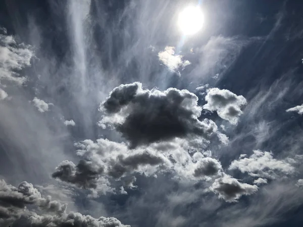 Dramatic spring white puffy clouds in the Southwest part of the United States. In meteorology, a cloud is an aerosol consisting of a visible mass of minute liquid droplets,