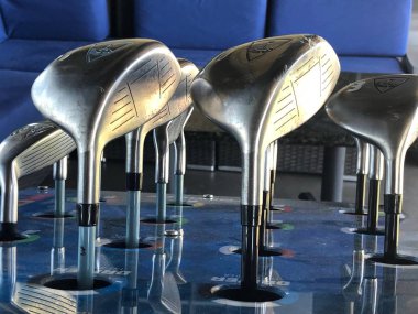 Golf kulüpleri müşteri için bir sürüş aralığında kutusunda oturan onlar topa vurmak için kullanmak için gidiyoruz hangi golf kulübü seçmek için.