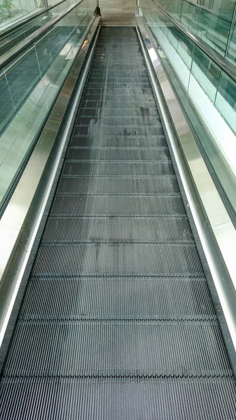 Empty escalator moving walkway in shopping mall