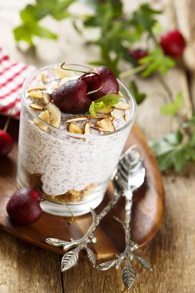 Chia seeds pudding with fresh cherry and almond flakes