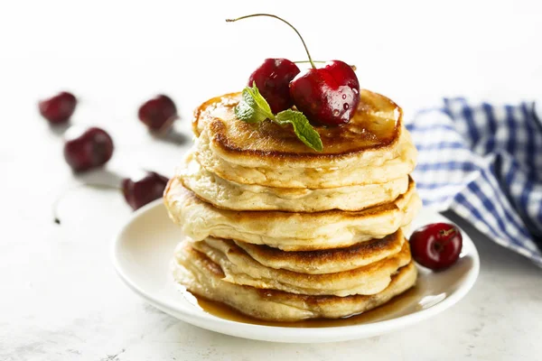 Homemade fluffy pancakes with fresh cherry