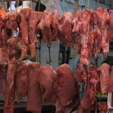 Hong Kong'da çiğ et, bir sokak pazarında sıcak sıcaklıklarda asılı