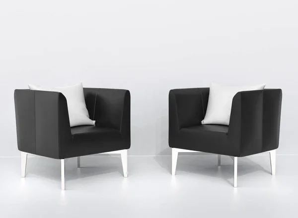 Two black leather armchairs with white pillows