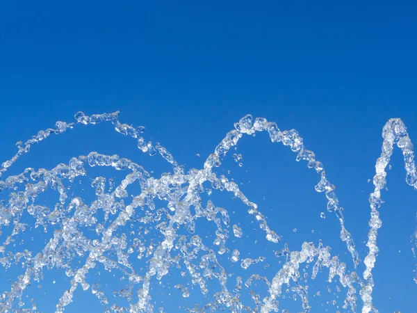 Water droplets and streams - blue sky background