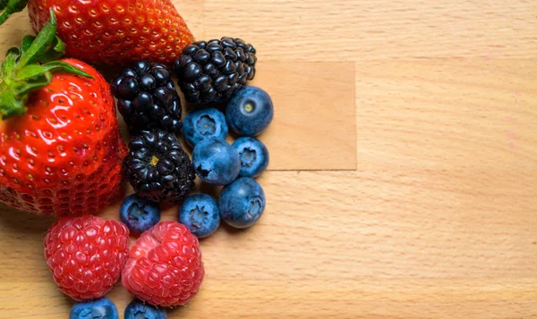 Assorted Berries on wood background — Stock Photo, Image