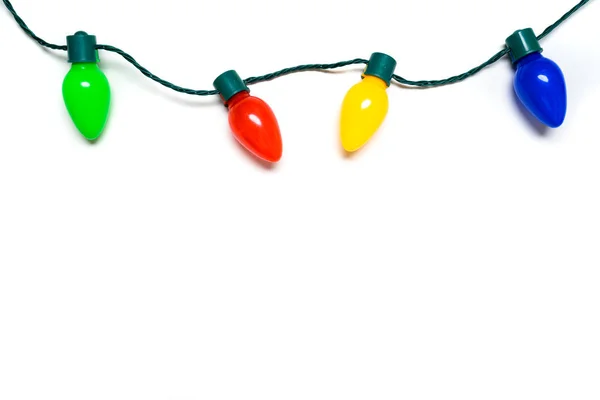 Beyaz arka planda renkli Noel ışıkları — Stok fotoğraf
