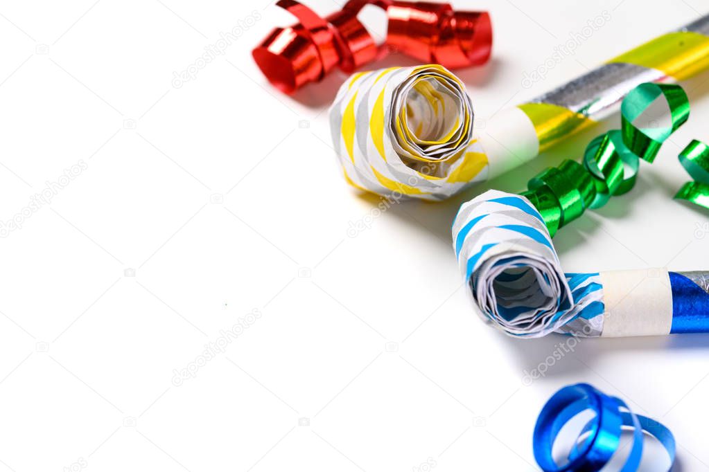 Colorful party noise makers on a white background