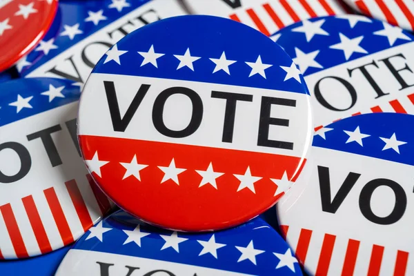 A group of red, white and blue VOTE button on a blue background — Stock Photo, Image