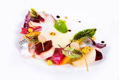 Salad or appetizer of salted fish with boiled vegetables - beets, carrots, potatoes, cucumbers, spices, herbs, sauce, capers, mustard on white background. Variation of salad Herring under fur coat.