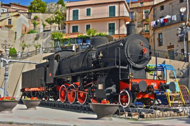 Old steam locomotive in the village of Bova in the Province of Reggio Calabria, Italy. clipart