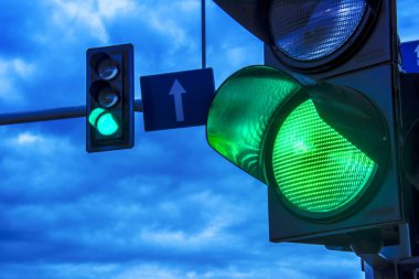 Traffic lights over urban intersection. clipart
