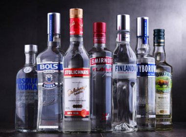 POZNAN, POLAND - NOV 15, 2018: Bottles of several global brands of vodka, the worlds largest internationally traded spirit with the estimated sale of about 500 million nine liter cases a year. clipart