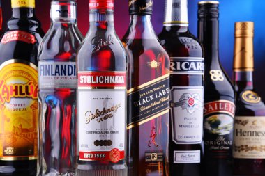 POZNAN, POLAND - NOV 16, 2018: Bottles of assorted global liquor brands including whiskey, vodka, cognac and liqueur clipart