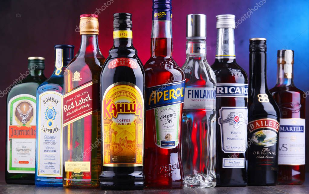 POZNAN, POLAND - NOV 16, 2018: Bottles of assorted global liquor brands including whiskey, vodka, gin, cognac and liqueur