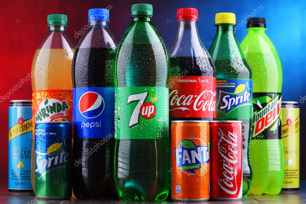 POZNAN, POLAND - NOV 16, 2018: Bottles and cans of global soft drink brands including products of Coca Cola Company and Pepsico