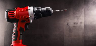 Cordless drill with drill bit working also as screw gun. clipart