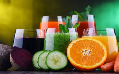 Glasses with fresh organic vegetable and fruit juices. Detox diet clipart
