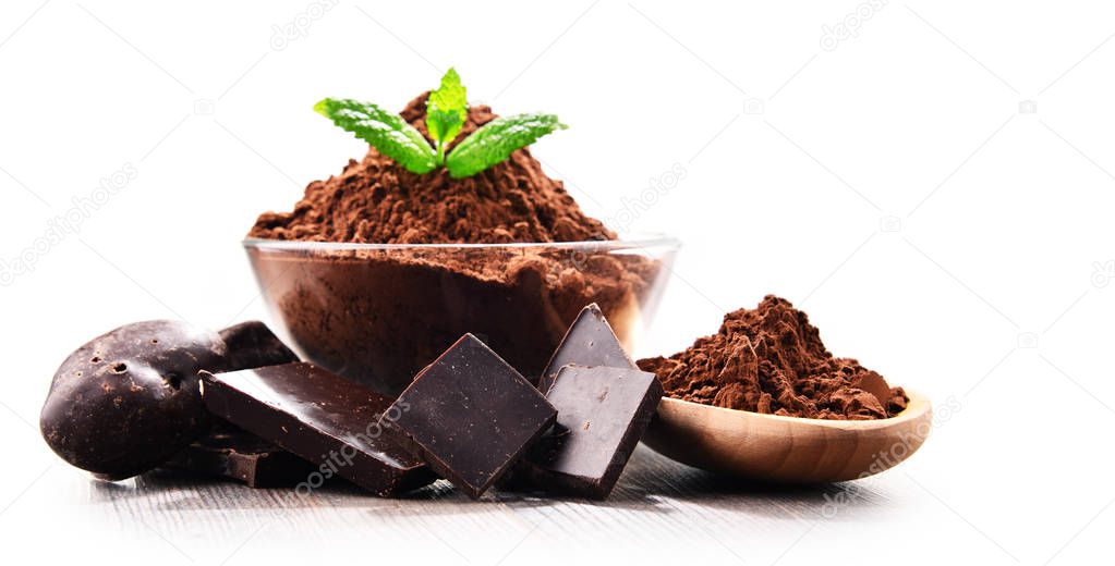 Composition with bowl of cocoa powder isolated on white.