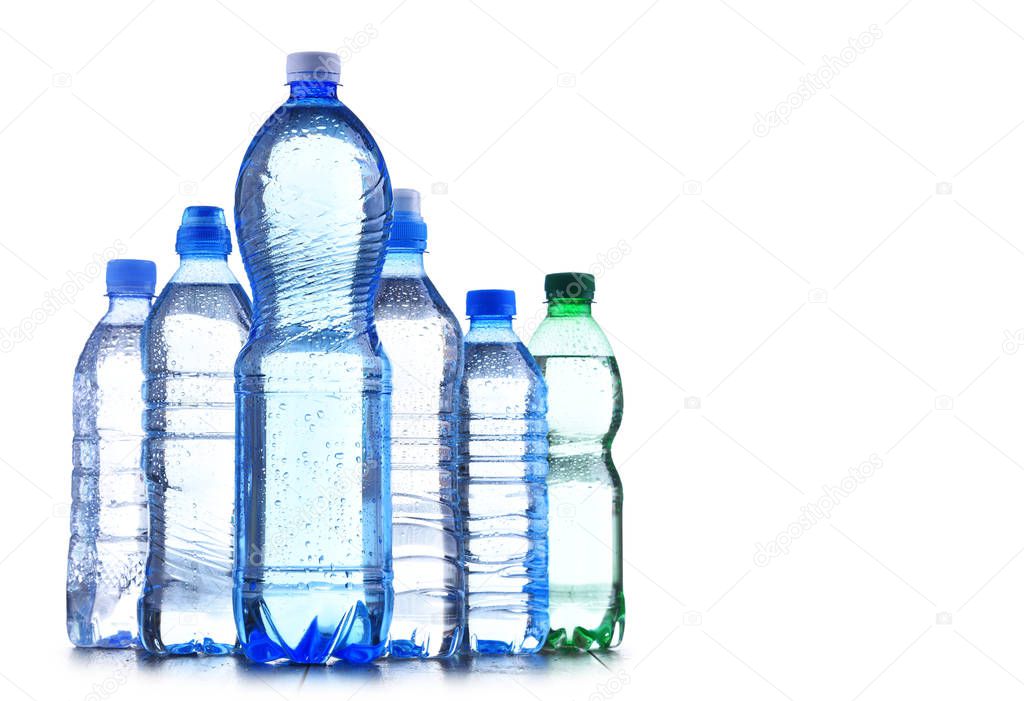 Composition with different sorts of bottles containing mineral water isolated on white