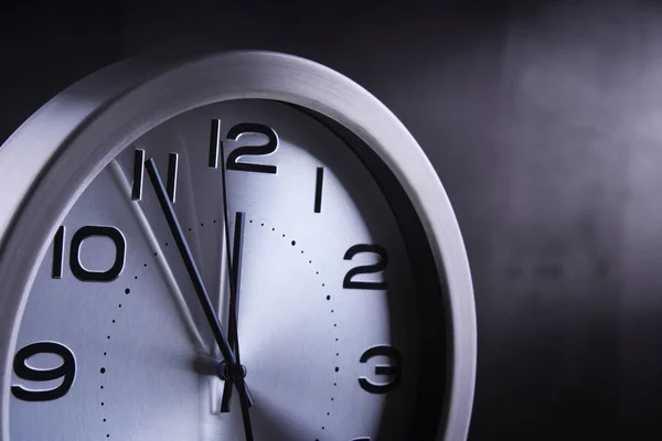 Modern wall clock showing five to twelve — Stock Photo, Image