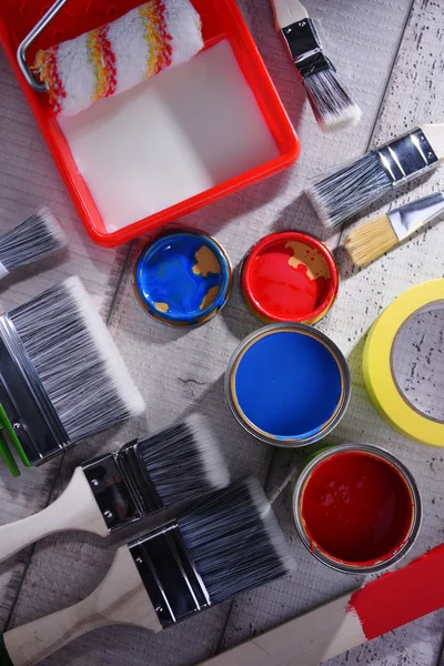 Paintbrushes of different size and paint can — Stock Photo, Image