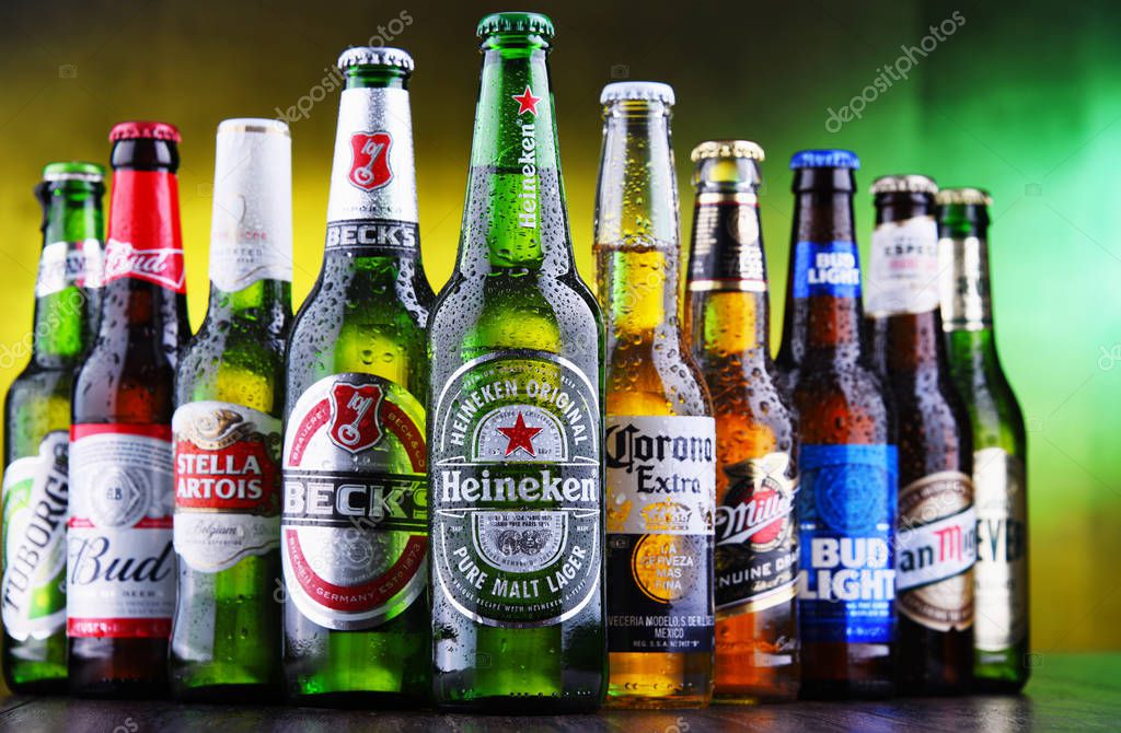POZNAN, POL - MAR 15, 2019: Bottles of famous global beer brands including Heineken, Becks, Bud, Miller, Corona, Stella Artois, and San Miguel