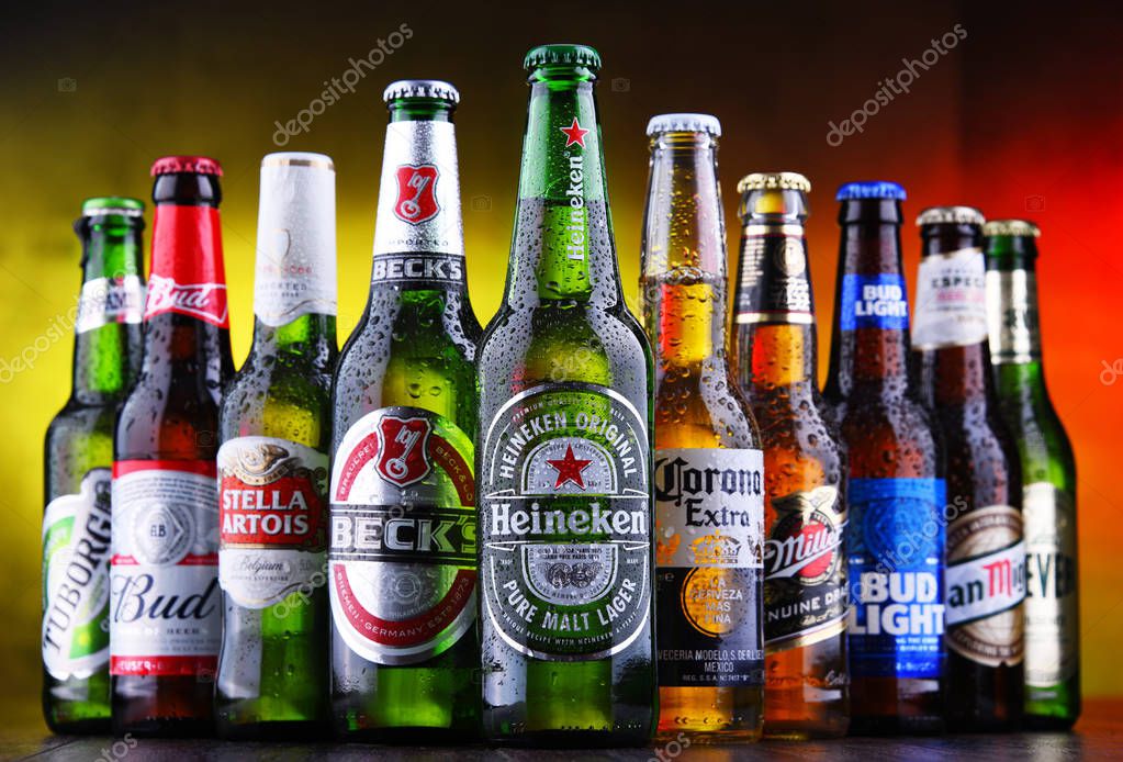 POZNAN, POL - MAR 15, 2019: Bottles of famous global beer brands including Heineken, Becks, Bud, Miller, Corona, Stella Artois, and San Miguel