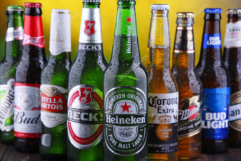 POZNAN, POL - MAR 15, 2019: Bottles of famous global beer brands including Heineken, Becks, Bud, Miller, Corona, Stella Artois, and San Miguel