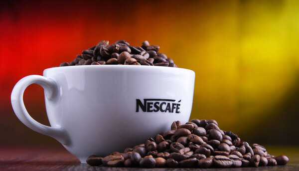 Composition with cup of Nescafe coffee beans