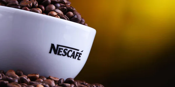 Zusammensetzung mit einer Tasse Nescafe Kaffeebohnen — Stockfoto