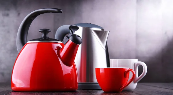 Плита чайник со свистом и электрический беспроводной чайник — стоковое фото
