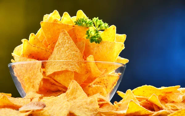 Composition with glass bowl of tortilla chips. — Stock Photo, Image