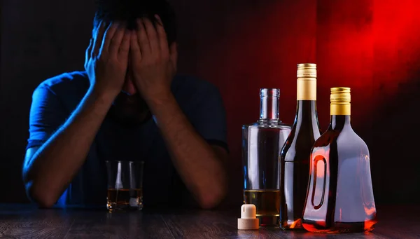 Flaschen mit alkoholischen Getränken und die Figur eines Betrunkenen — Stockfoto