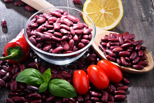 Composition with bowl of kidney bean on wooden table — Stock Photo, Image