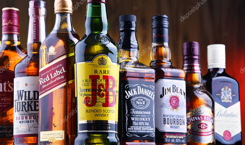 POZNAN, POLAND - JUL 5, 2019: Bottles of several global whiskey brands, the most popular liquor in the world.