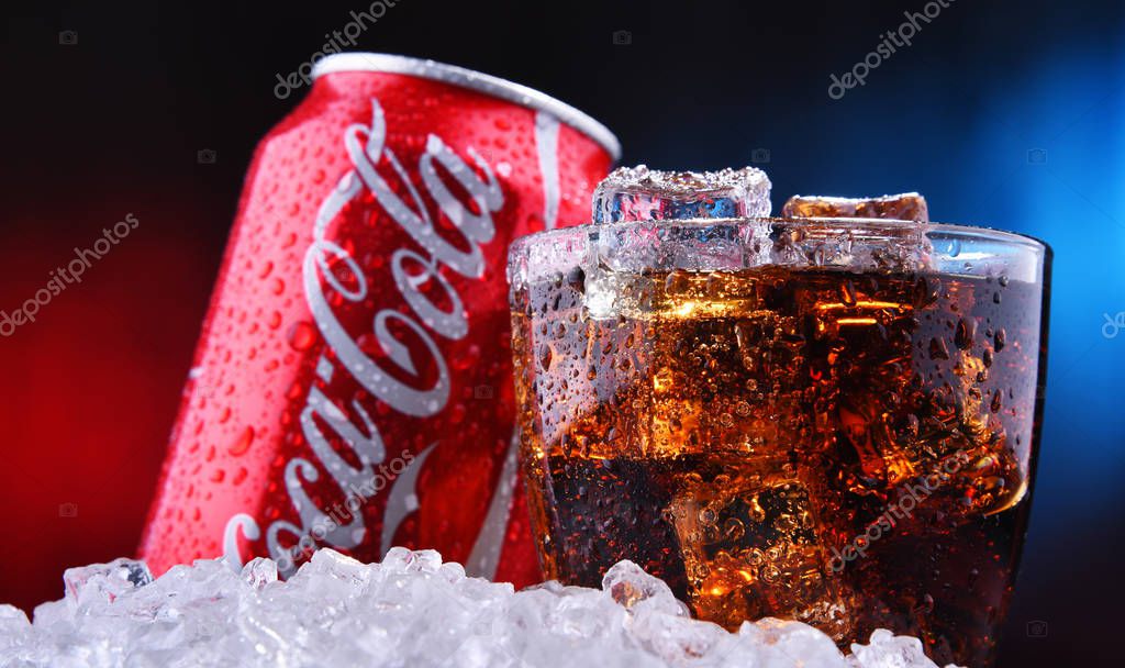 POZNAN, POL - AUG 13, 2019: A glass and a can of Coca-Cola, a carbonated soft drink manufactured by The Coca-Cola Company headquartered in Atlanta, Georgia, USA