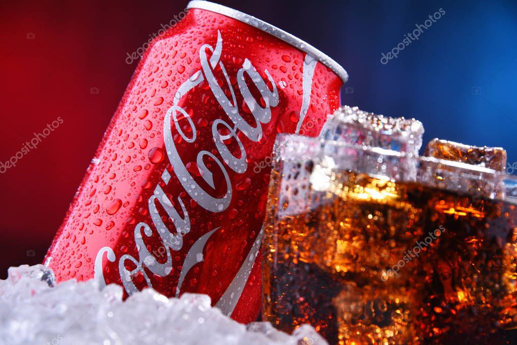 POZNAN, POL - AUG 13, 2019: A glass and a can of Coca-Cola, a carbonated soft drink manufactured by The Coca-Cola Company headquartered in Atlanta, Georgia, USA