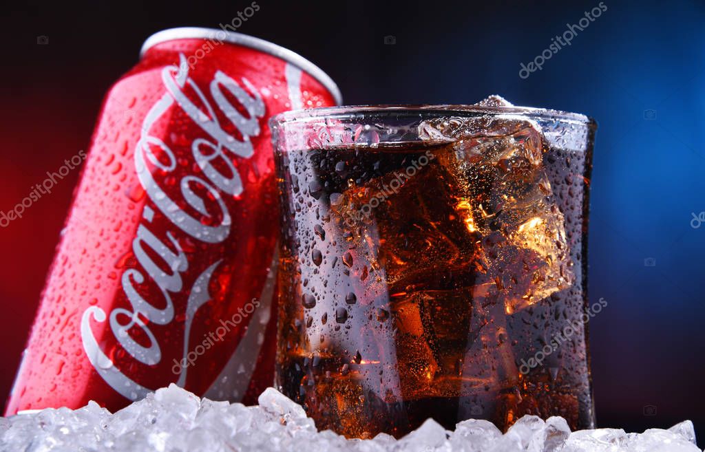 POZNAN, POL - AUG 13, 2019: A glass and a can of Coca-Cola, a carbonated soft drink manufactured by The Coca-Cola Company headquartered in Atlanta, Georgia, USA