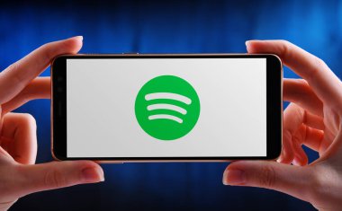 POZNAN, POL - 21 Mayıs 2020: Spotify 'ın akıllı telefon logosu, plak şirketleri ve medya şirketlerinden müzik ve podcast sağlayan İsveçli bir ses yayını platformu