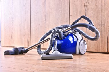 Dairedeki zemin panellerinde ev kullanımı için teneke süpürge..