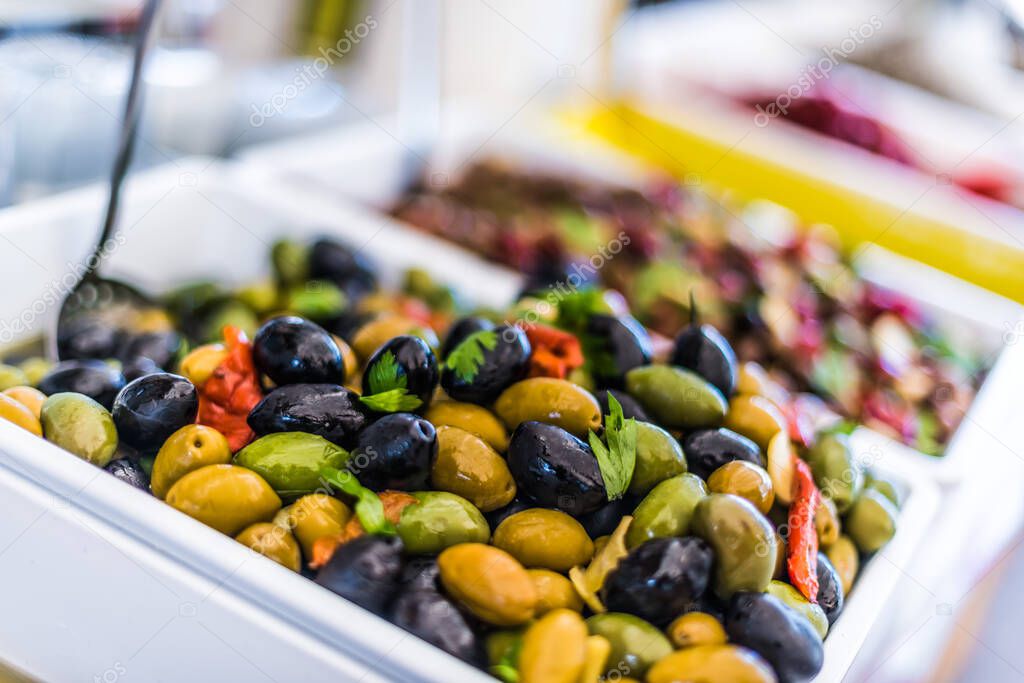 Assorted olives put up for sale on the italian street market stall.