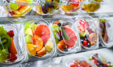 Plastic boxes with pre-packaged fruit salads, put up for sale in a commercial refrigerator