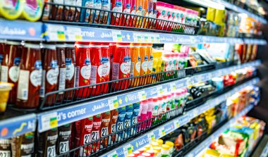 MUSCAT, OMAN - MAR 14, 2024: Dairy products put out for sale in a commercial refrigerator in a supermarket
