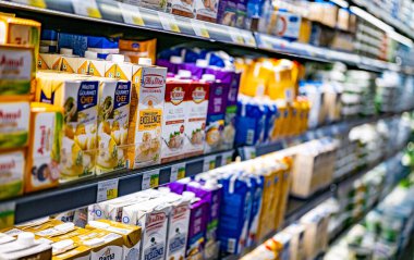 MUSCAT, OMAN - MAR 14, 2024: Dairy products put out for sale in a commercial refrigerator in a supermarket
