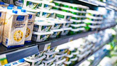 MUSCAT, OMAN - MAR 14, 2024: Dairy products put out for sale in a commercial refrigerator in a supermarket