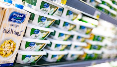 MUSCAT, OMAN - MAR 14, 2024: Dairy products put out for sale in a commercial refrigerator in a supermarket