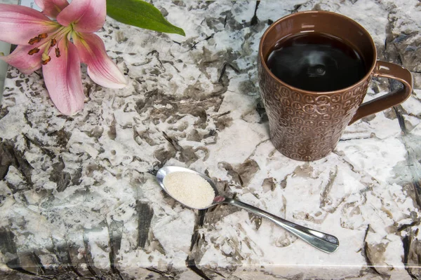 Granite countertop with coffee and flower on it