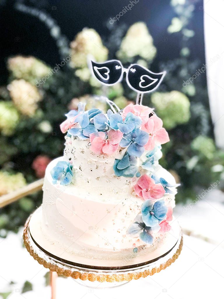 Wedding creamy white cake with beautiful floral decoration