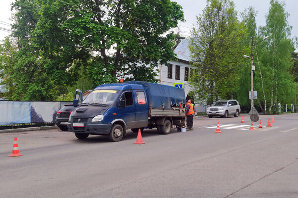 Moscow, Russia, 28.05.2020. Employees of the road service carry out painting and maintenance of the road section. Workers made a new pedestrian crossing. editorial use only, poorly performed work and the road is blocked